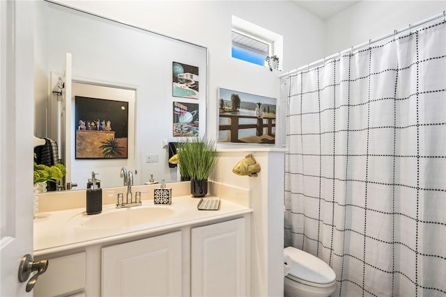 bathroom with vanity, toilet, and walk in shower