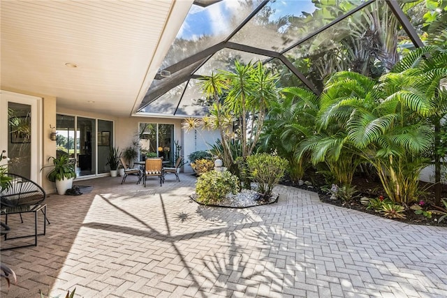 view of patio featuring glass enclosure