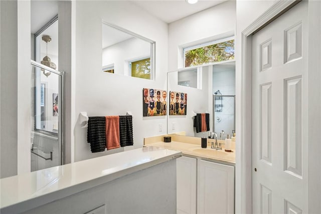 bathroom with vanity and a shower with shower door