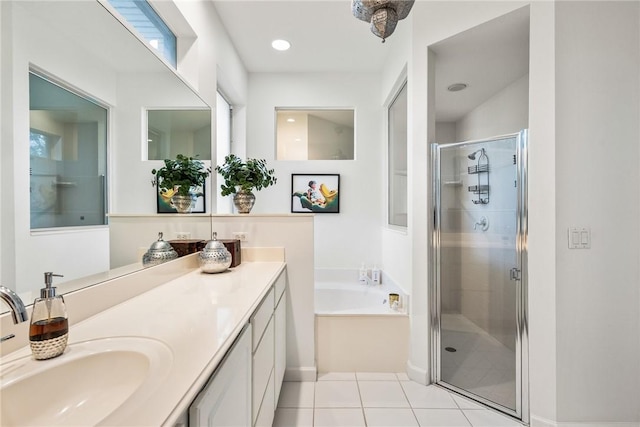 bathroom with tile patterned flooring, vanity, and plus walk in shower