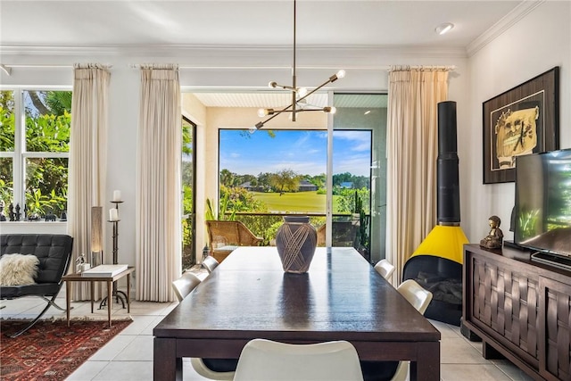 tiled dining area featuring an inviting chandelier and ornamental molding