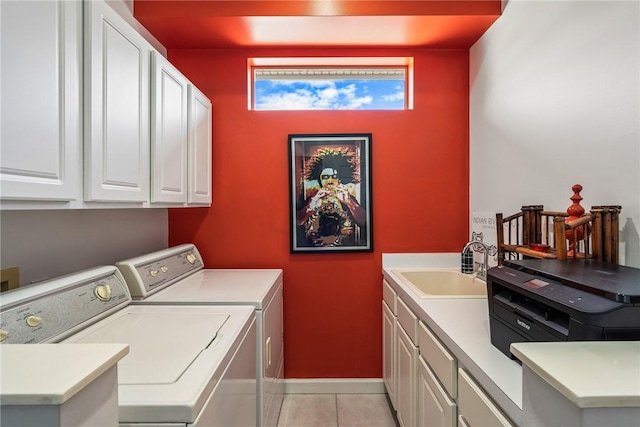 laundry area with cabinets, independent washer and dryer, light tile patterned flooring, and sink