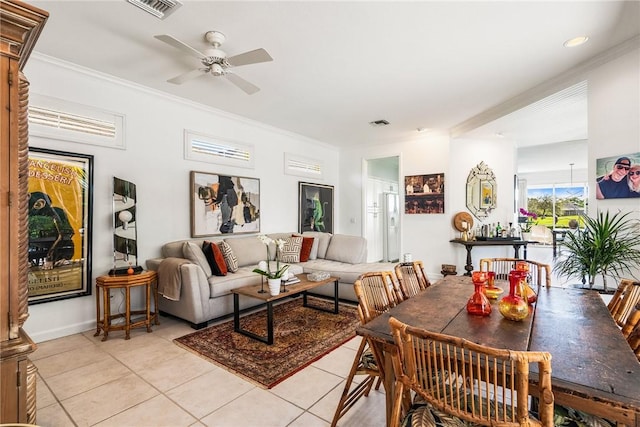 tiled living room with ceiling fan and crown molding