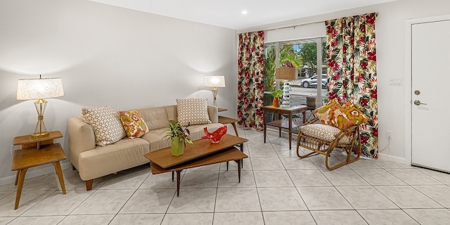 living area with light tile patterned floors and baseboards