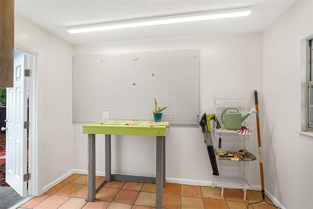 850 Gilbert St, Sebastian, FL 32958 - kitchen with tile patterned floors, baseboards, and a textured ceiling