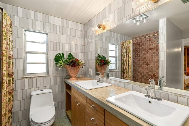 850 Gilbert St, Sebastian, FL 32958 - bathroom featuring tile walls, toilet, plenty of natural light, a shower with curtain, and double vanity
