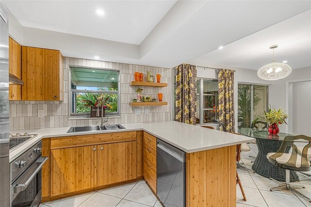 850 Gilbert St, Sebastian, FL 32958 - kitchen featuring stainless steel appliances, a sink, a peninsula, light tile patterned floors, and recessed lighting