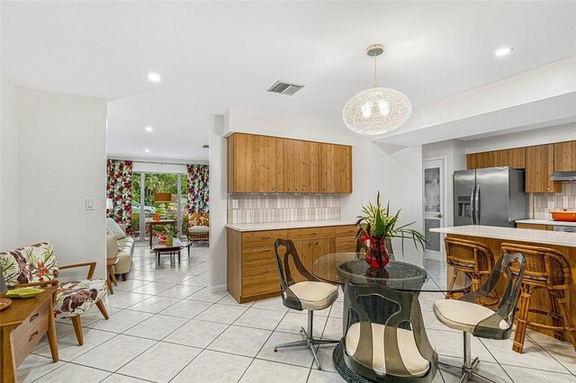 850 Gilbert St, Sebastian, FL 32958 - dining room with light tile patterned floors, a chandelier, and recessed lighting