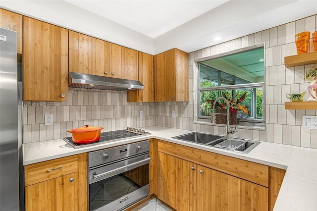 850 Gilbert St, Sebastian, FL 32958 - kitchen with stainless steel appliances, under cabinet range hood, a sink, open shelves, and decorative backsplash
