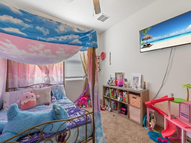 carpeted bedroom featuring visible vents and ceiling fan