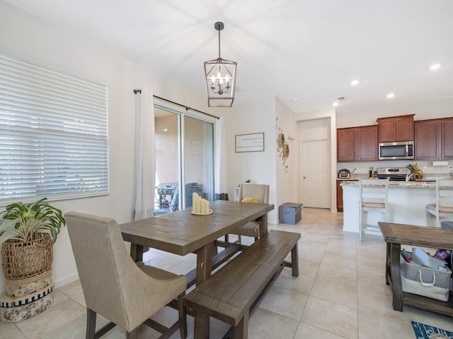 dining space featuring recessed lighting, a chandelier, and light tile patterned floors