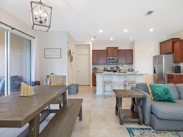 dining space with an inviting chandelier, light tile patterned floors, recessed lighting, and visible vents