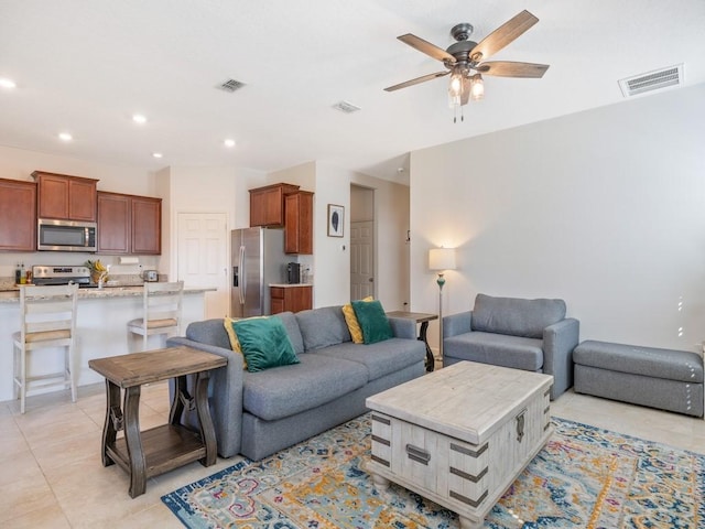 living area with light tile patterned floors, visible vents, ceiling fan, and recessed lighting