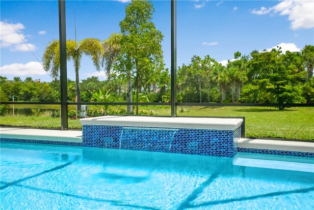 view of pool featuring a lawn