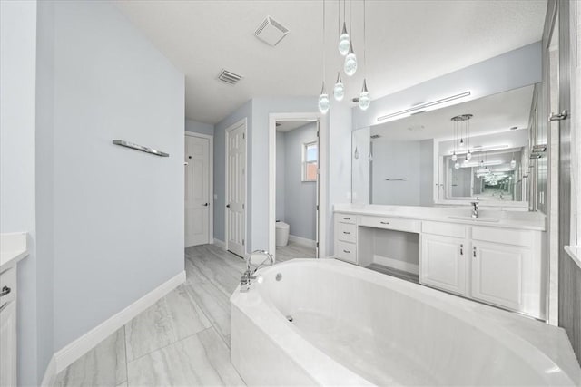 bathroom featuring vanity, a bathtub, and toilet