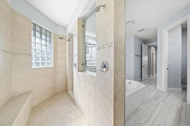 bathroom featuring separate shower and tub