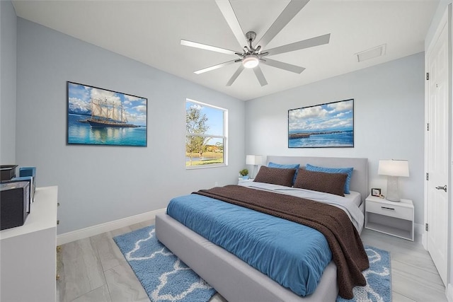 bedroom with ceiling fan and light hardwood / wood-style flooring