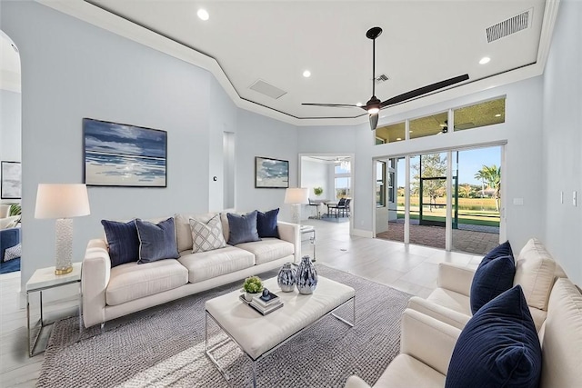 living room with crown molding and ceiling fan