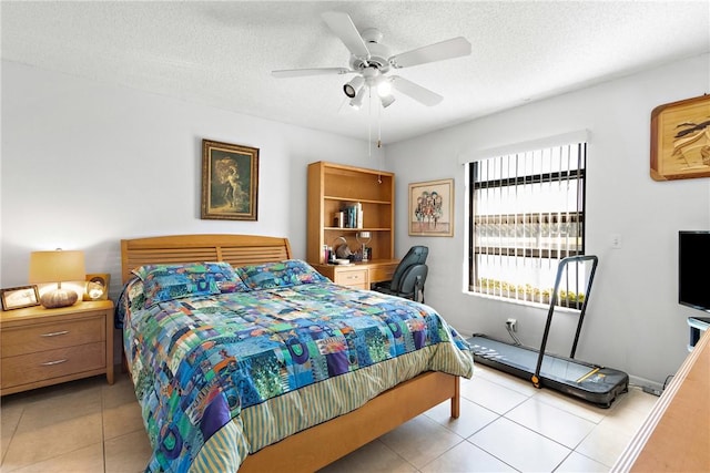 tiled bedroom with ceiling fan and a textured ceiling