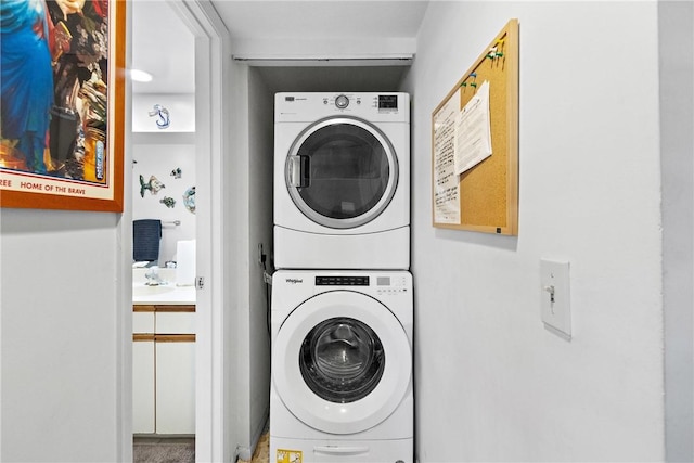 laundry area featuring stacked washer / drying machine