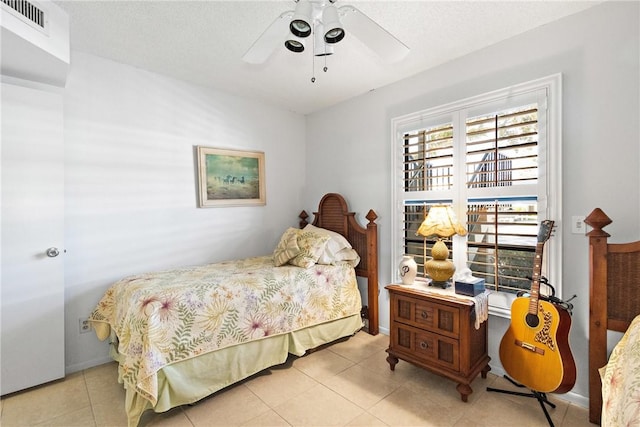 bedroom featuring light tile patterned floors and ceiling fan