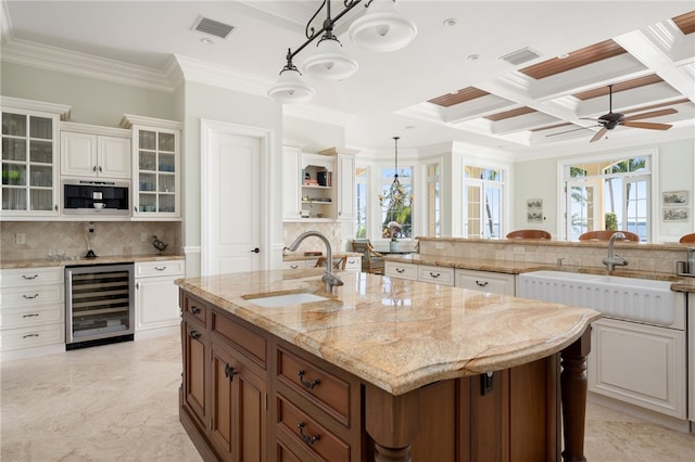 kitchen featuring a sink, visible vents, and beverage cooler