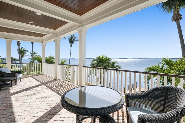 view of patio / terrace featuring a water view and a balcony