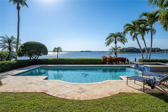 view of pool featuring a water view, a pool with connected hot tub, and a patio area