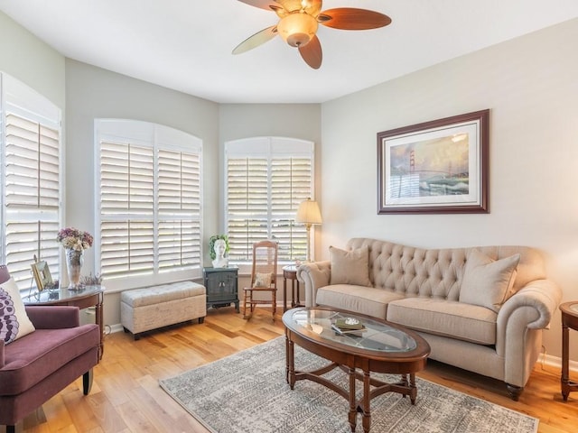 living room featuring ceiling fan and light hardwood / wood-style flooring