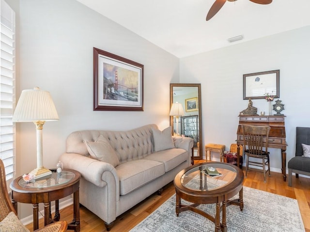 living room with ceiling fan and light hardwood / wood-style flooring