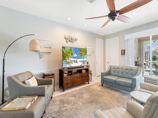 carpeted living room with ceiling fan