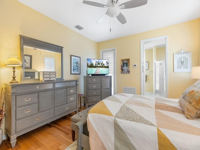 bedroom featuring ceiling fan, ensuite bathroom, and light hardwood / wood-style flooring