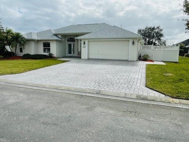 view of front facade featuring a front yard and a garage