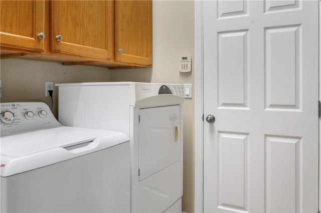 washroom with cabinets and separate washer and dryer