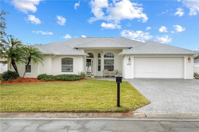 view of front of home with a front lawn and a garage