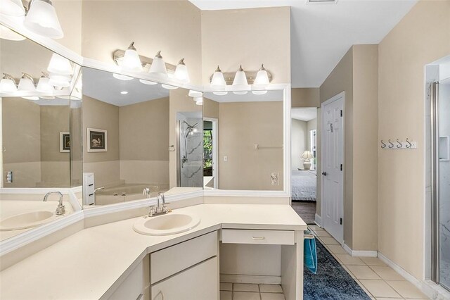 ensuite bathroom with a stall shower, ensuite bath, tile patterned floors, vanity, and a bath