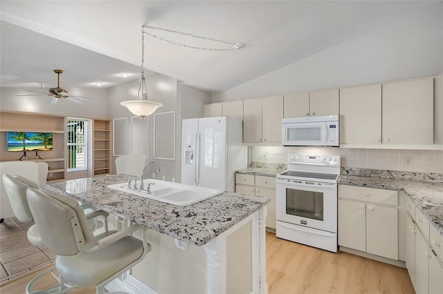 kitchen with lofted ceiling, a kitchen island with sink, white appliances, a sink, and light wood finished floors