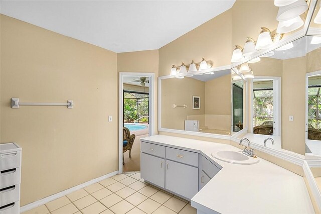 ensuite bathroom featuring tile patterned floors, connected bathroom, a wealth of natural light, and vanity