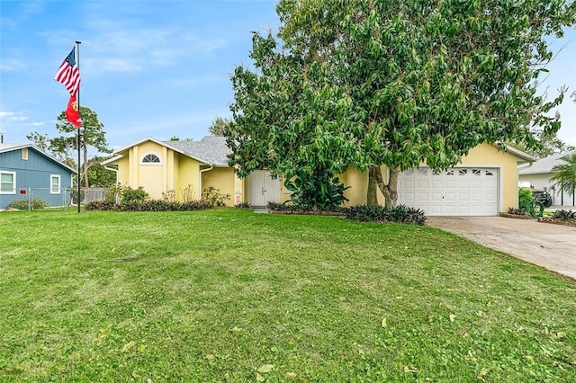 view of front of property featuring a garage, fence, concrete driveway, stucco siding, and a front lawn