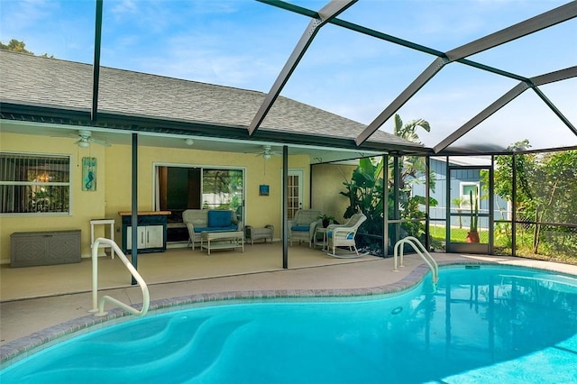 pool with ceiling fan, glass enclosure, a patio area, and an outdoor living space