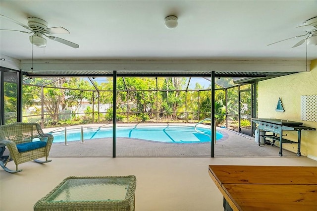 view of swimming pool featuring ceiling fan, glass enclosure, a patio, and a fenced in pool