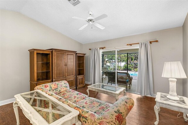 bedroom with access to outside, dark wood finished floors, visible vents, and vaulted ceiling