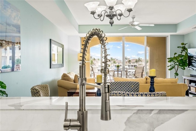 5520 N Harbor Village Dr Unit 204, Vero Beach, FL 32967 - living room with a ceiling fan, a chandelier, and plenty of natural light