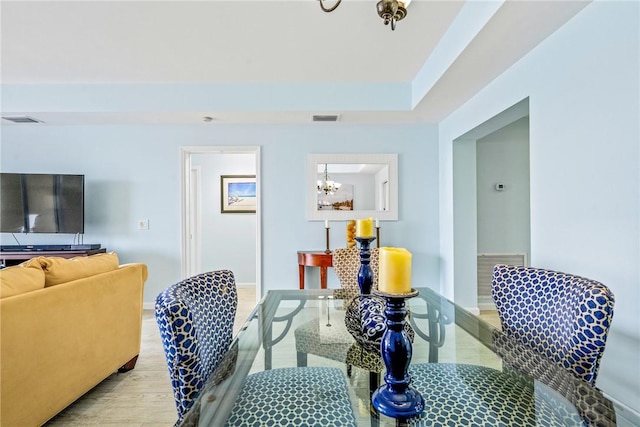5520 N Harbor Village Dr Unit 204, Vero Beach, FL 32967 - dining space with wood finished floors, a chandelier, and baseboards