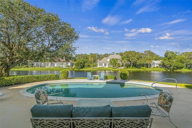 view of pool featuring a water view and a patio area