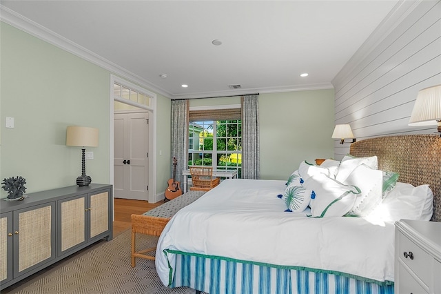 bedroom with light hardwood / wood-style floors and ornamental molding