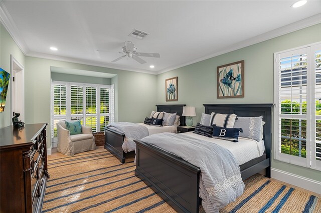 bedroom featuring ornamental molding, light wood-type flooring, and ceiling fan