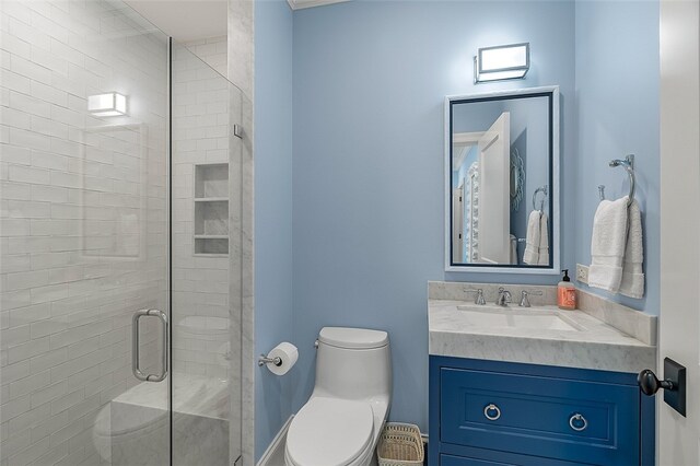 bathroom with walk in shower, vanity, and toilet