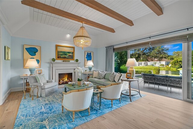 living room featuring light hardwood / wood-style floors, beamed ceiling, and an inviting chandelier