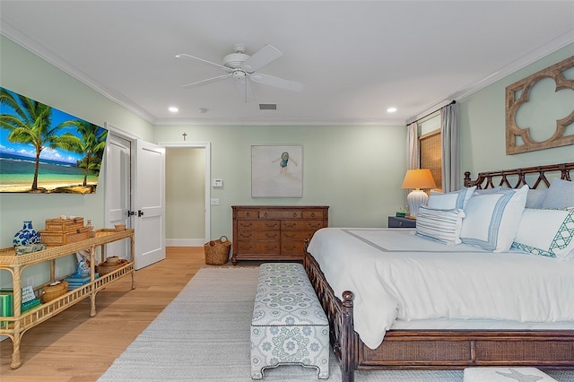 bedroom featuring ceiling fan, light hardwood / wood-style flooring, and crown molding